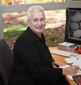 Photo of Dr. Diane Blau sitting behind her desk in her office.