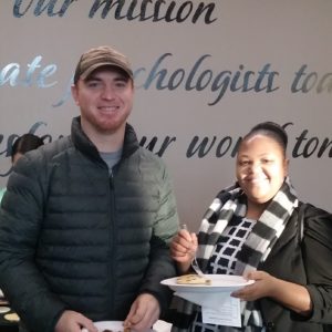 Two students holding plates of pancakes