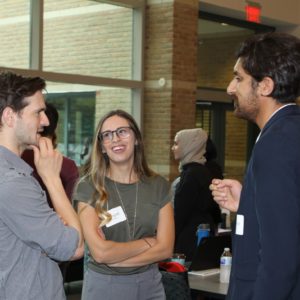 Photo of three students mingling in the atrium