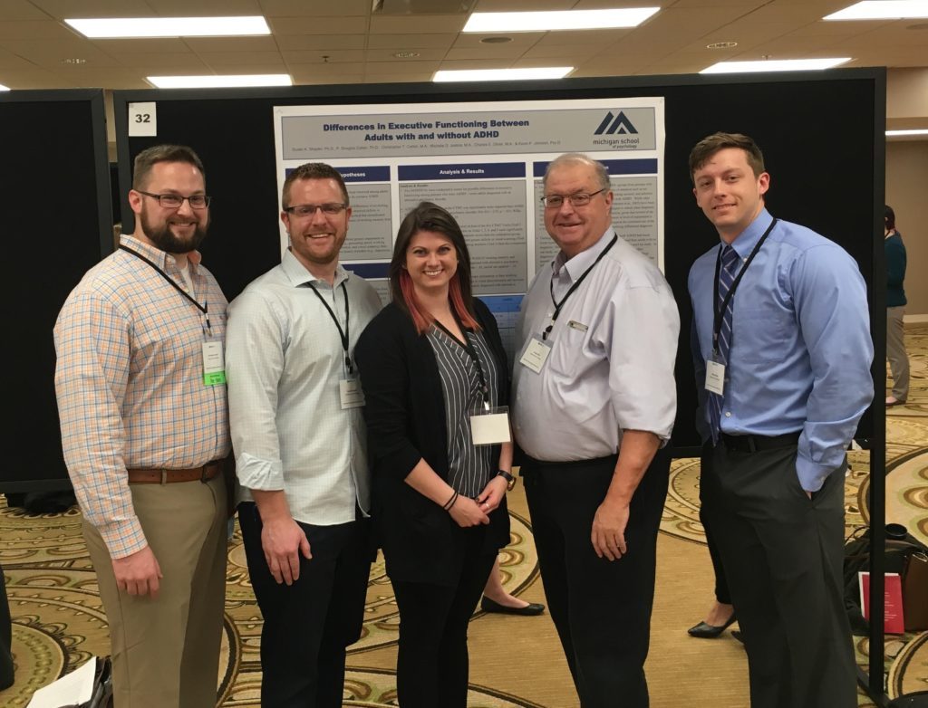 MSP students and staff posing with research poster "Difference in Executive Functioning Between Adults with and without ADHD"