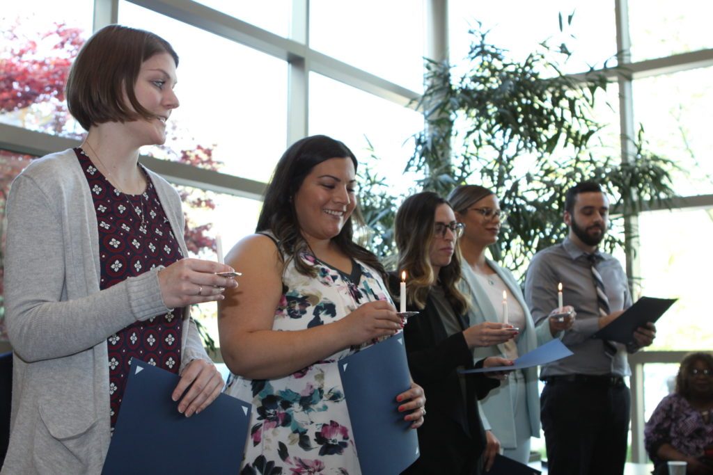 Photo of students holding candles during Psi Chi induction