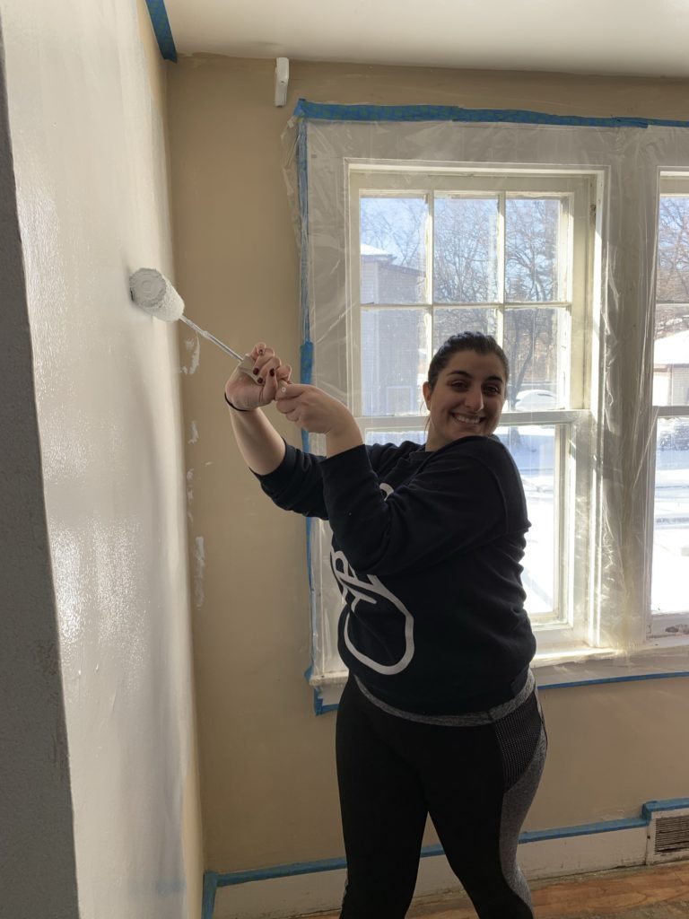 Student painting a wall