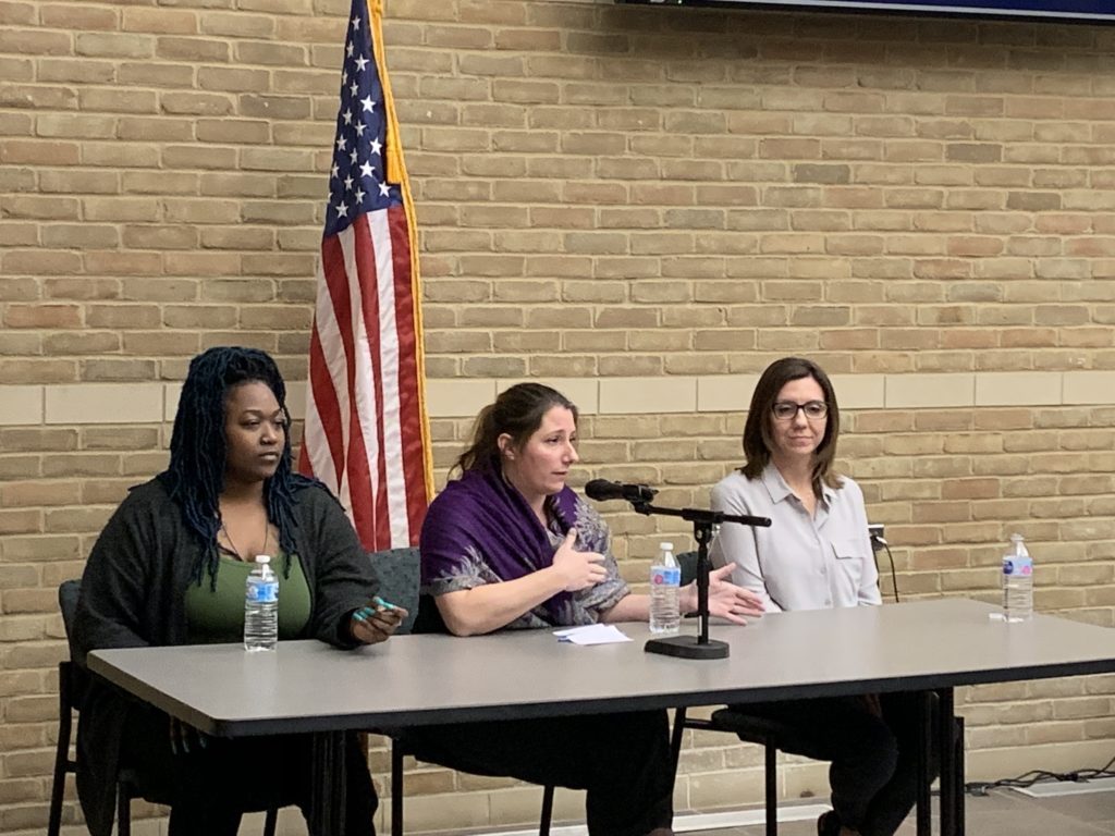 Photo of three panelists sitting at a table