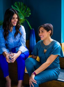 Image of two adults sitting and smiling.