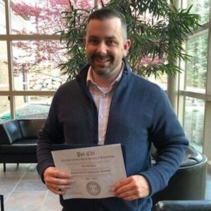 Scott MacInnis holding his Psi Chi certificate