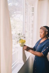 Stock photo of a woman arranging flowers.