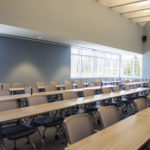 Photo of long tables with chairs in the MSP lecture hall