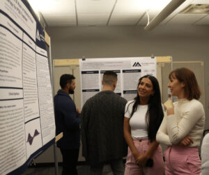 Two students looking at a research poster.