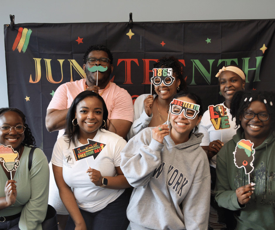 Members of the ABPsi SC with photo booth props and a Juneteenth backdrop