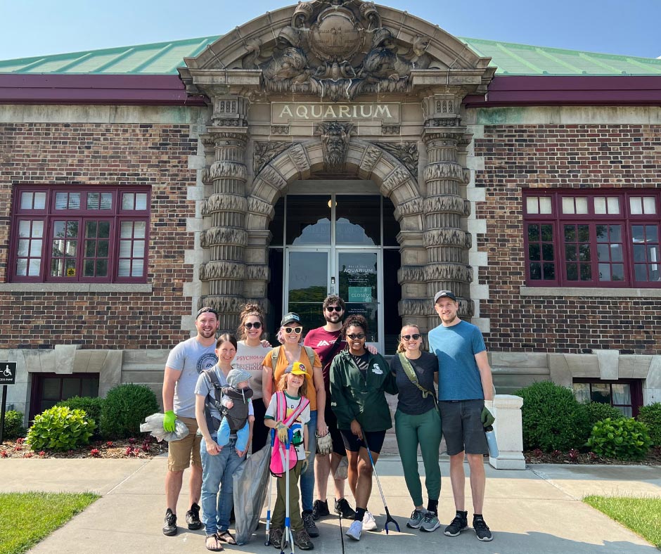 Members of the MSP community standing in front of the Belle Isle aquarium.