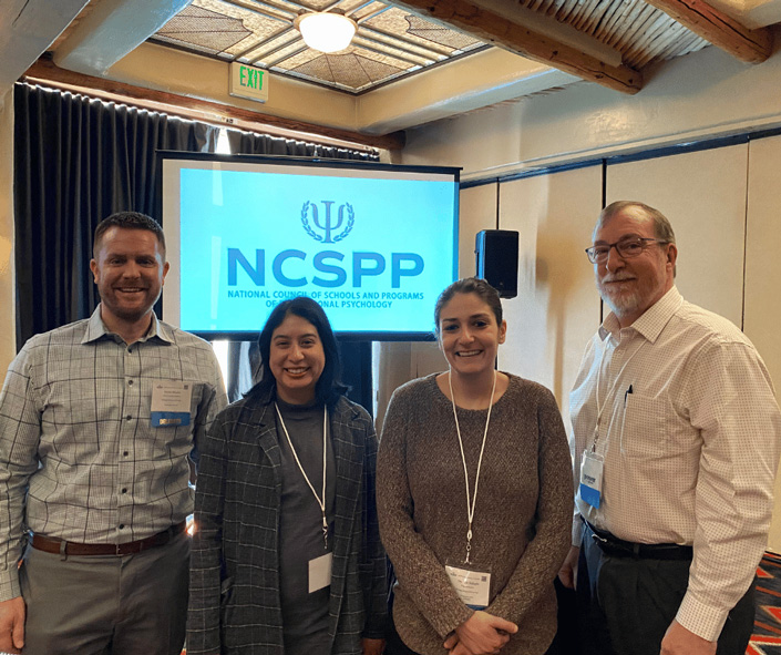 Dr. Shepler, Erica Medina, Dr. Balaghi, and Dr. Tyler in front of NCSPP sign