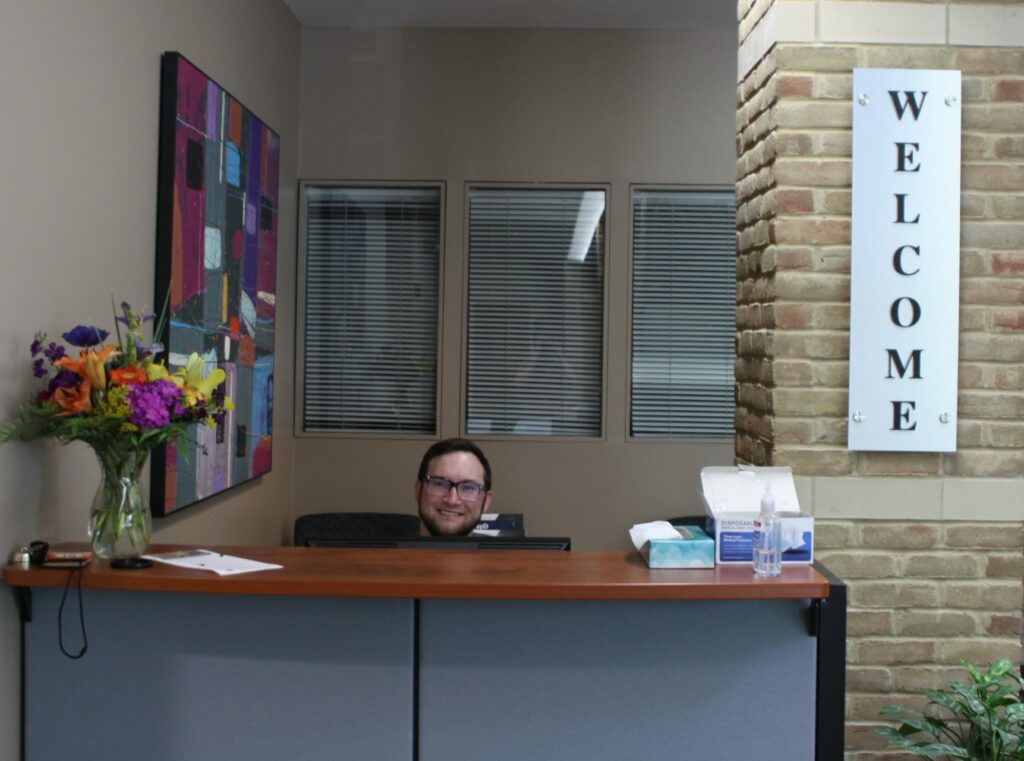 Photo of student assistant at front desk
