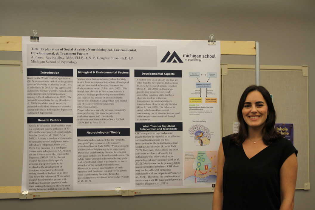 Ray Kaidbay standing with her research poster.