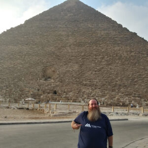 Photo of Dr. Blackstock in front of the pyramid