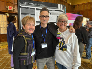 Dr. Bach, Michael Valenti, and Dr. King pose in front of Michael's poster.