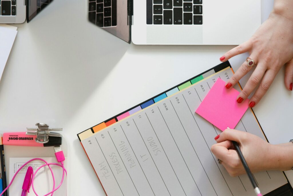 stock photo of a woman's hand writing in a planner.