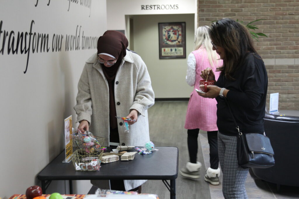 Photo of students looking at self-care kit table.