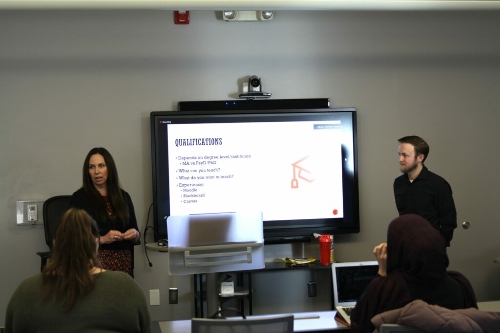 Photo of Drs. Cusick and Johnson giving a presentation to a classroom.