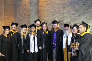 MA graduates posing with Dr. Keenan