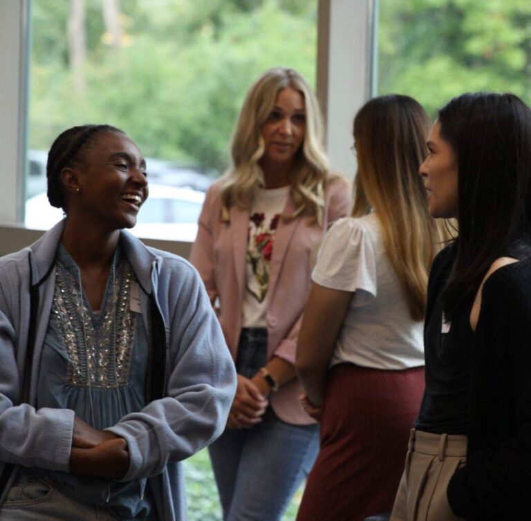 Photo of students talking and laughing in the atrium at MSP.