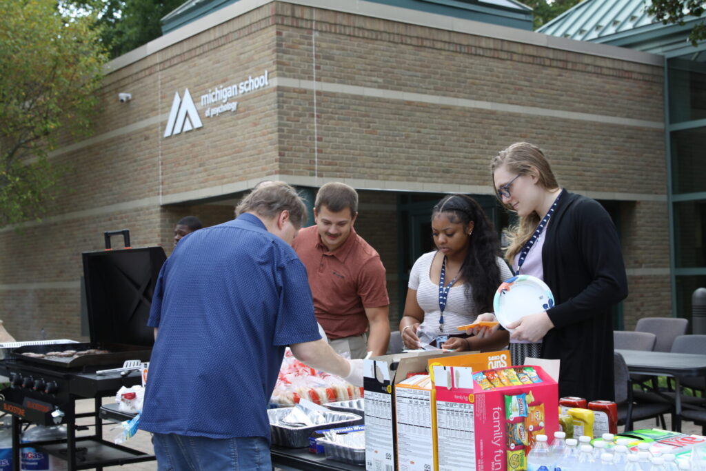 Jeff Cross grilled hot dogs, burgers, and veggie burgers for students.