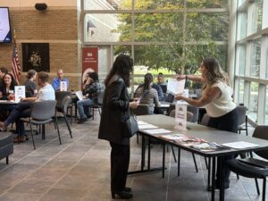 Photo a prospective student being shown a hand out at an open house